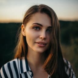 Woman with brown hair smiling softly